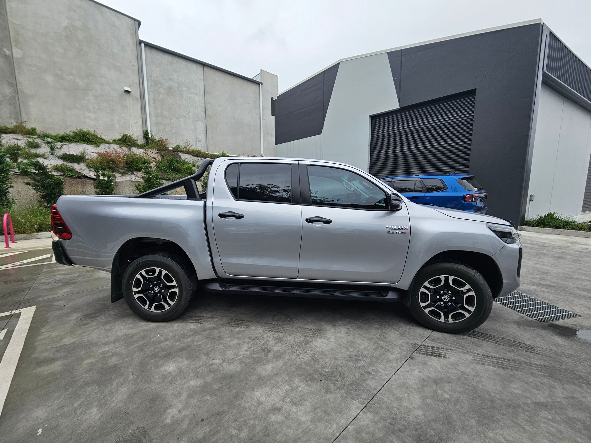 A white suv with a tent on top of it is parked in a garage.