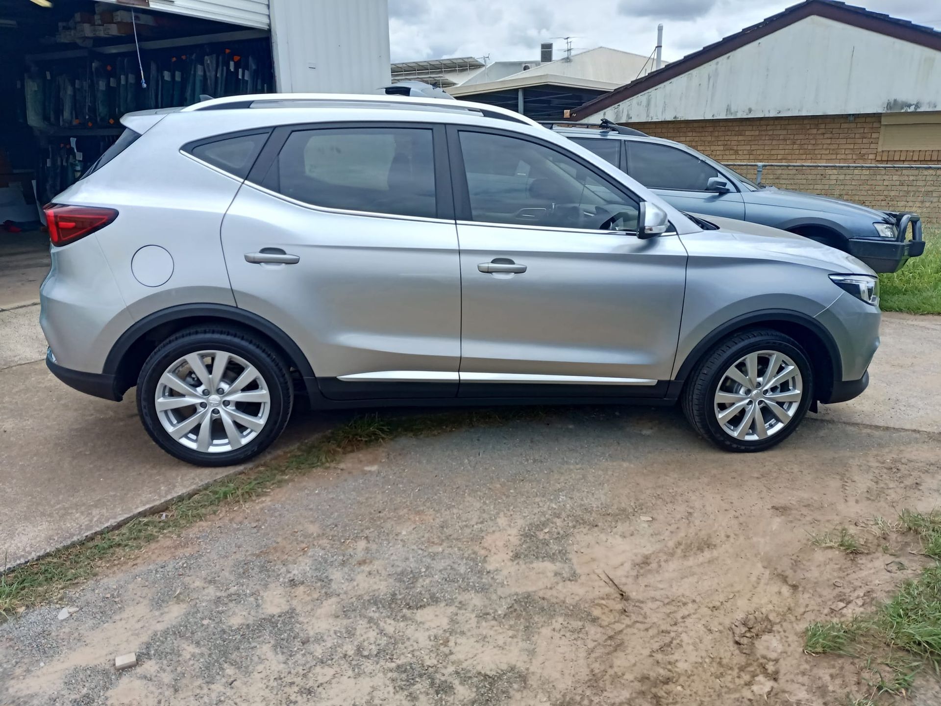Silver SUV parked on a concrete surface.