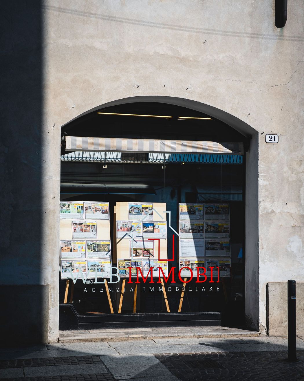 Tre persone in abiti da lavoro si incontrano a un tavolo, discutono di documenti, sorridendo.