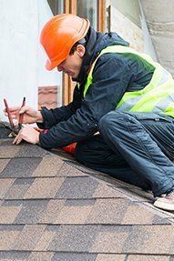 Roofing Installations — Man Repairing The Roof in Chester, PA