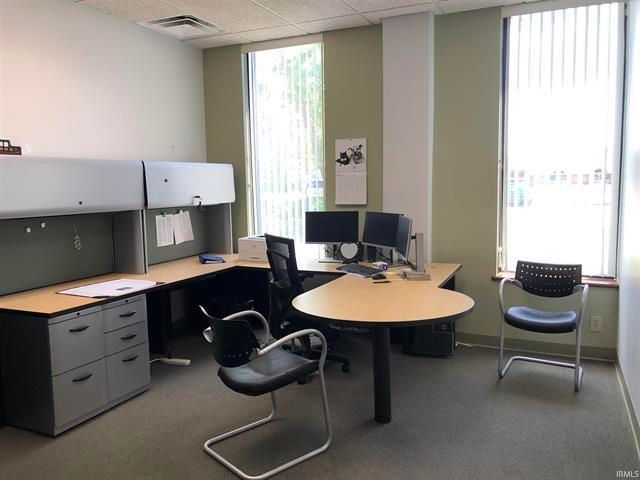 A small office with two desks and two chairs