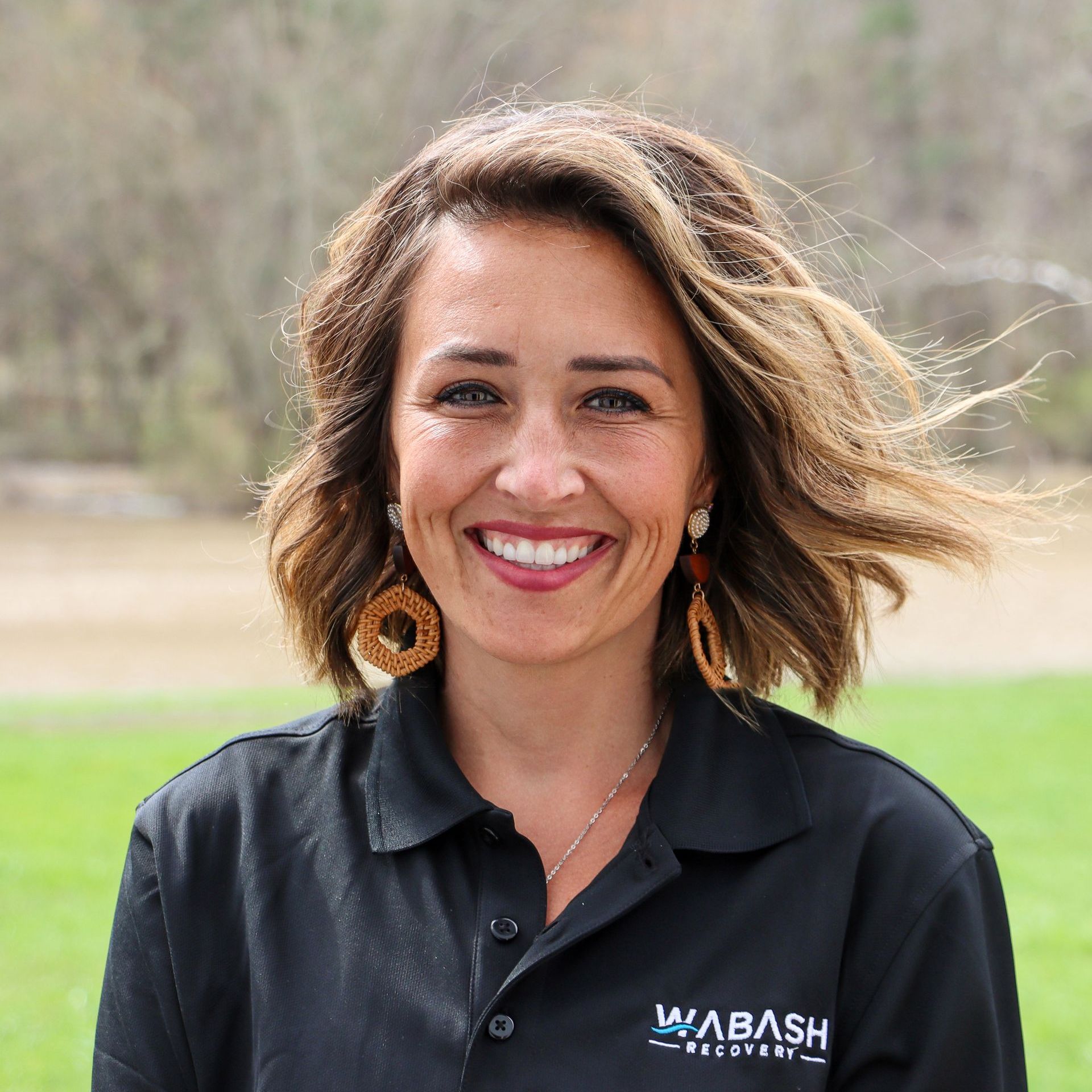 A woman wearing a wabash shirt is smiling for the camera