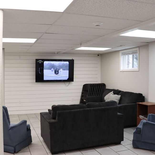 A living room with a flat screen tv on the wall