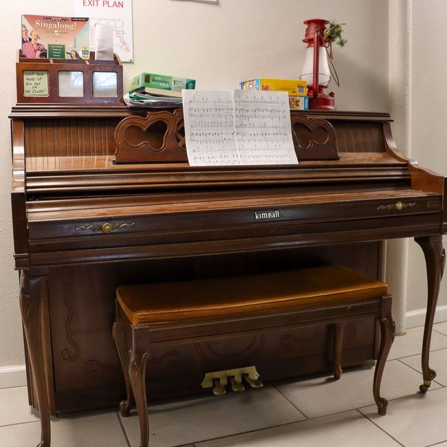 A piano with a sheet of music on top of it