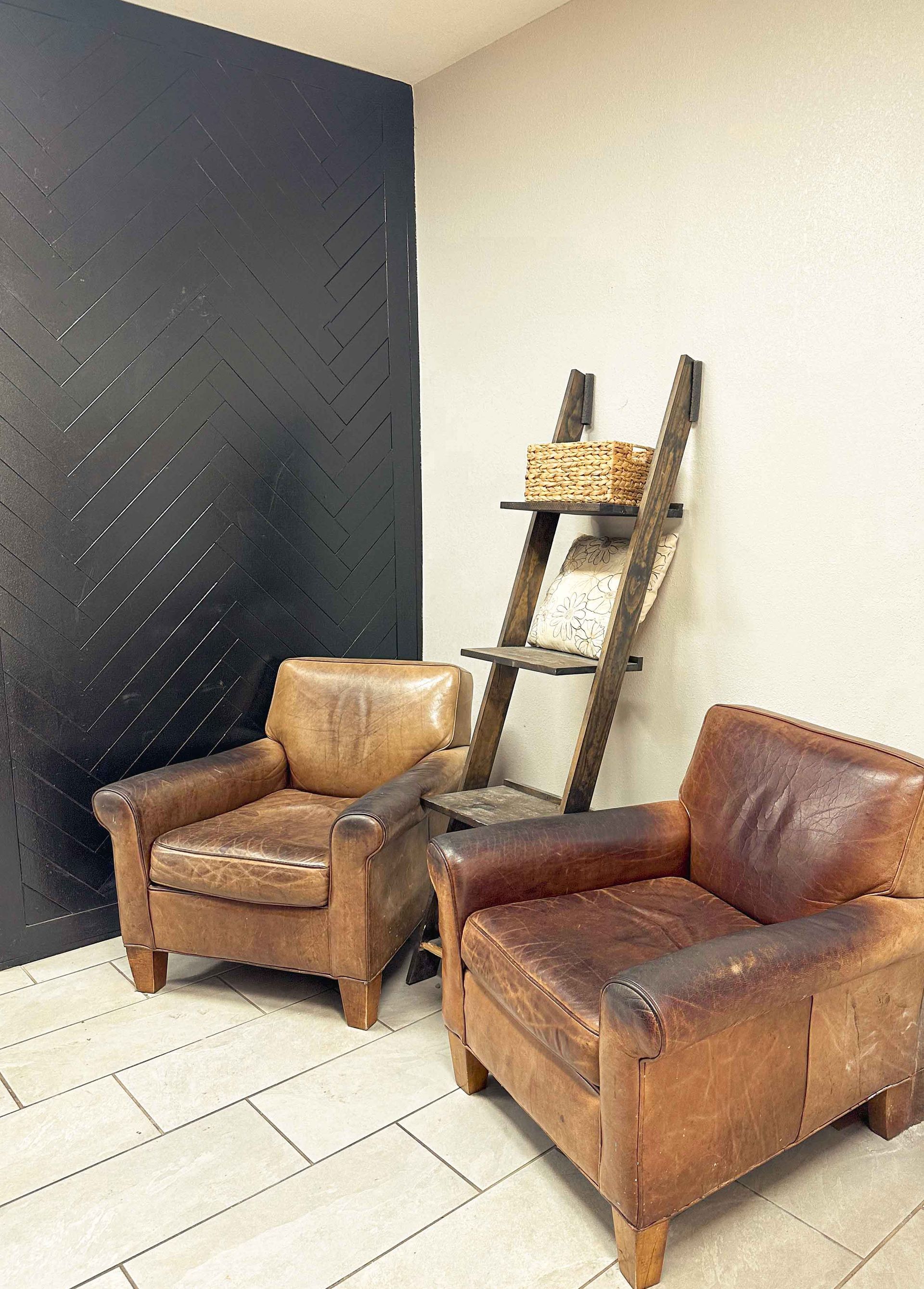Two brown leather chairs are sitting next to each other in a room.