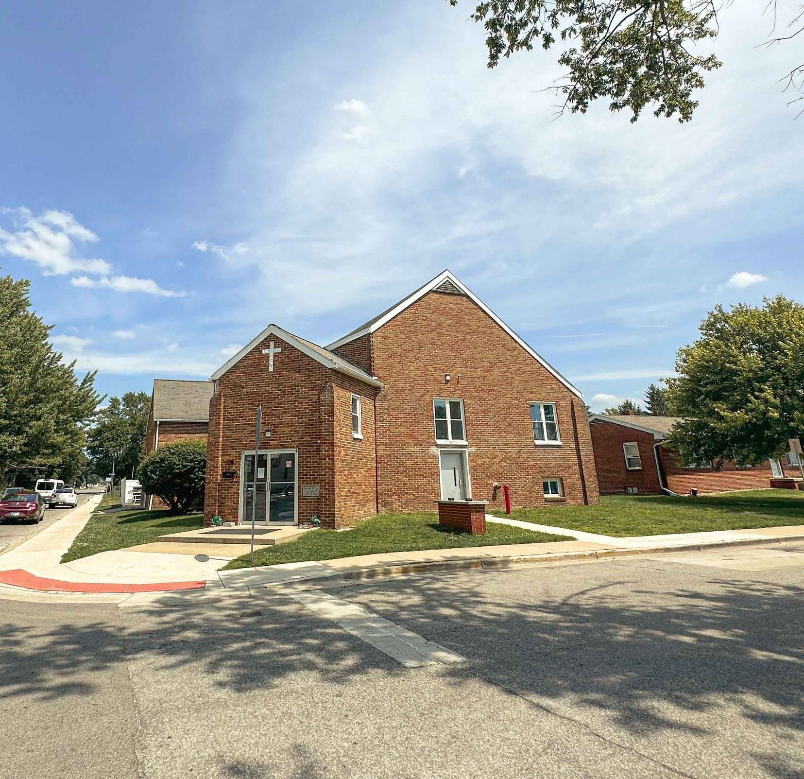 A brick building with a cross on the top of it