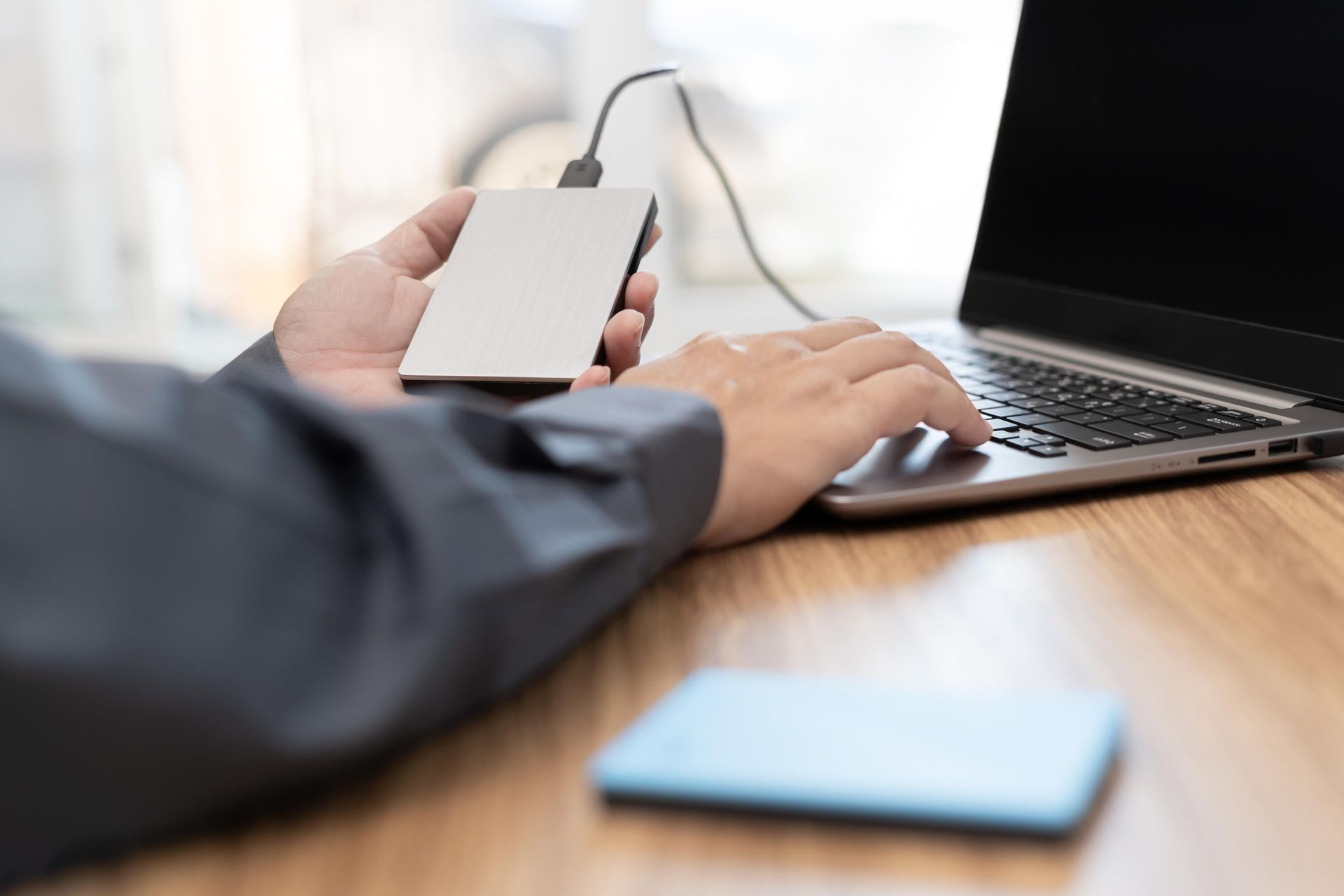 A living room with two couches, a fireplace, and a ceiling fan.