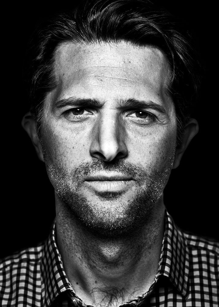 A classical photographic portraiture work, a close up of a man in incredible detail, shot in black and white.