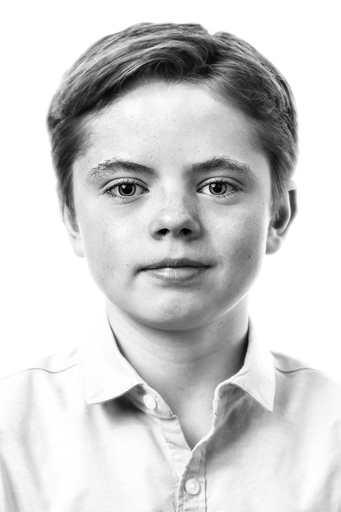 A classical photographic portraiture work, a close up of a young girl in incredible detail, shot in black and white.