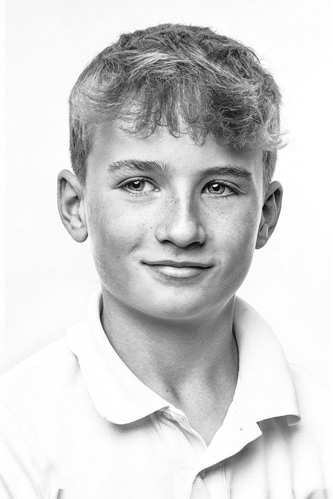 A classical photographic portraiture work, a close up of a young girl in incredible detail, shot in black and white.
