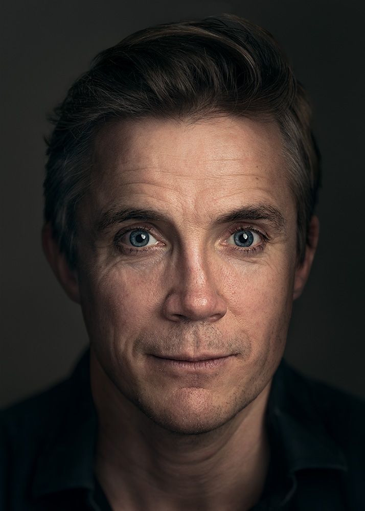 A classical photographic portraiture work, a close up of a man in incredible detail, with the eyes as a central focus.