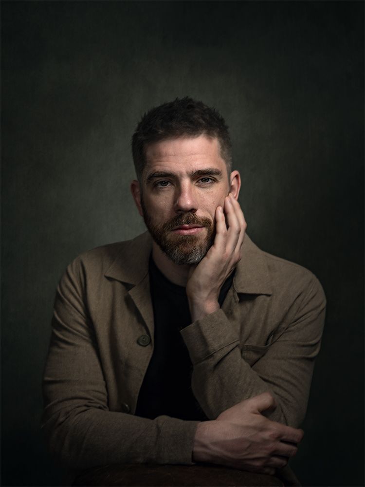 Fine art portrait of a man looking at us