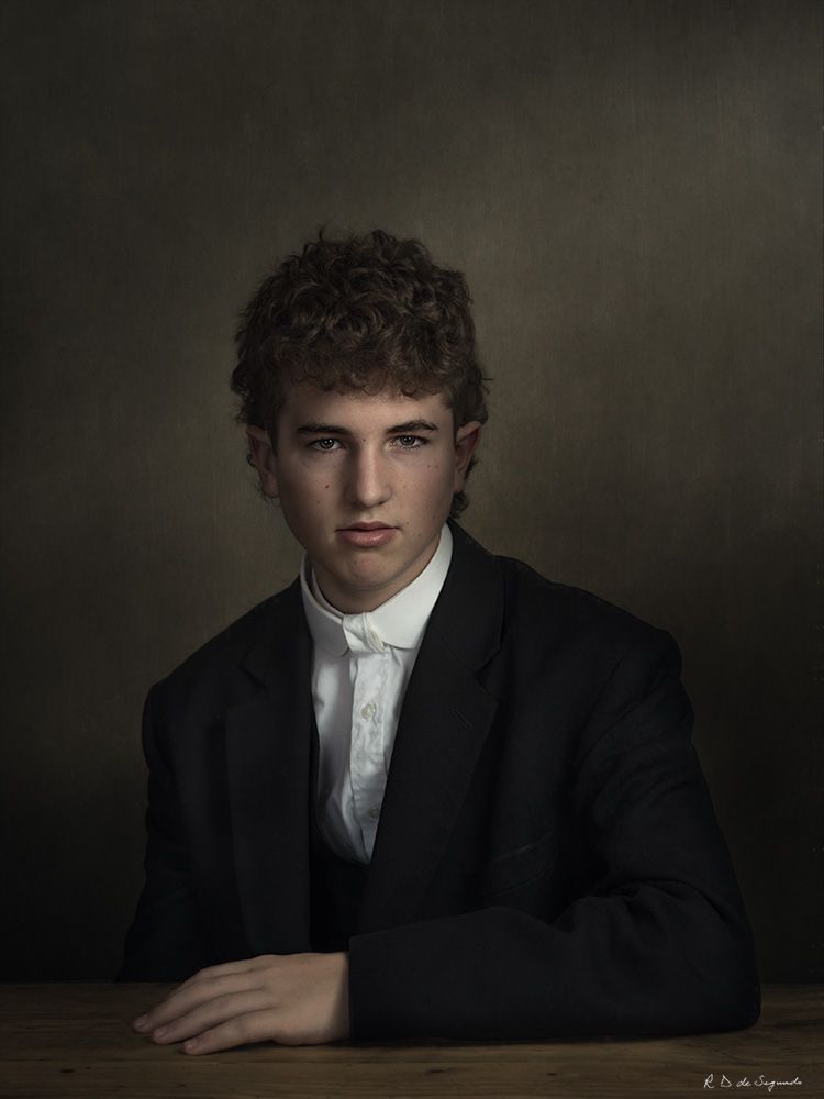 Studio fine art photo portrait of a young man using intricate lighting to emulate a soft media portrait from the Golden Age.