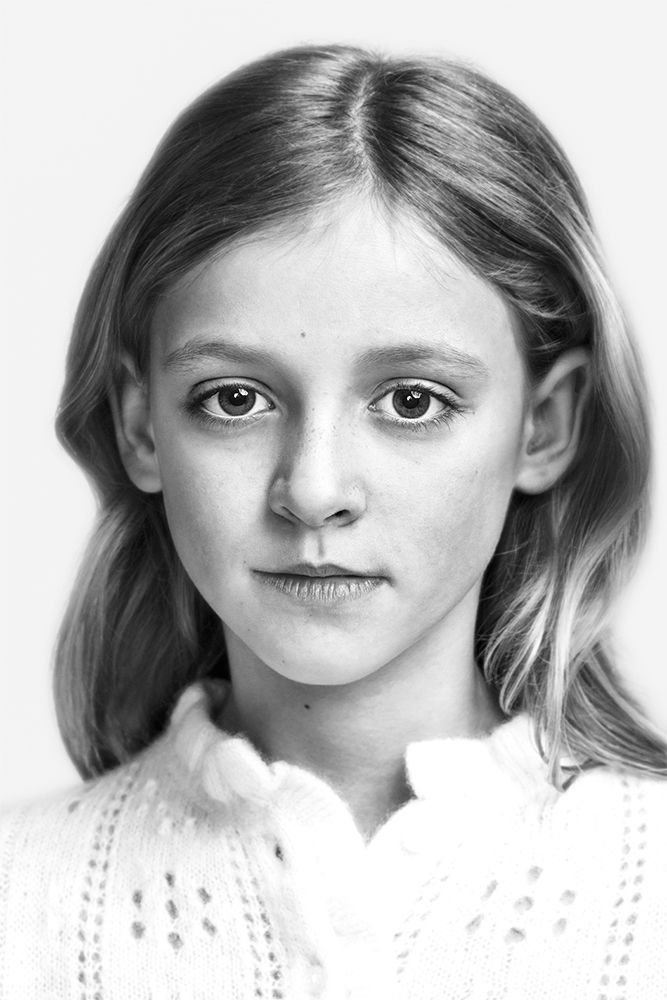 A classical photographic portraiture work, a close up of a young girl in incredible detail, shot in black and white.