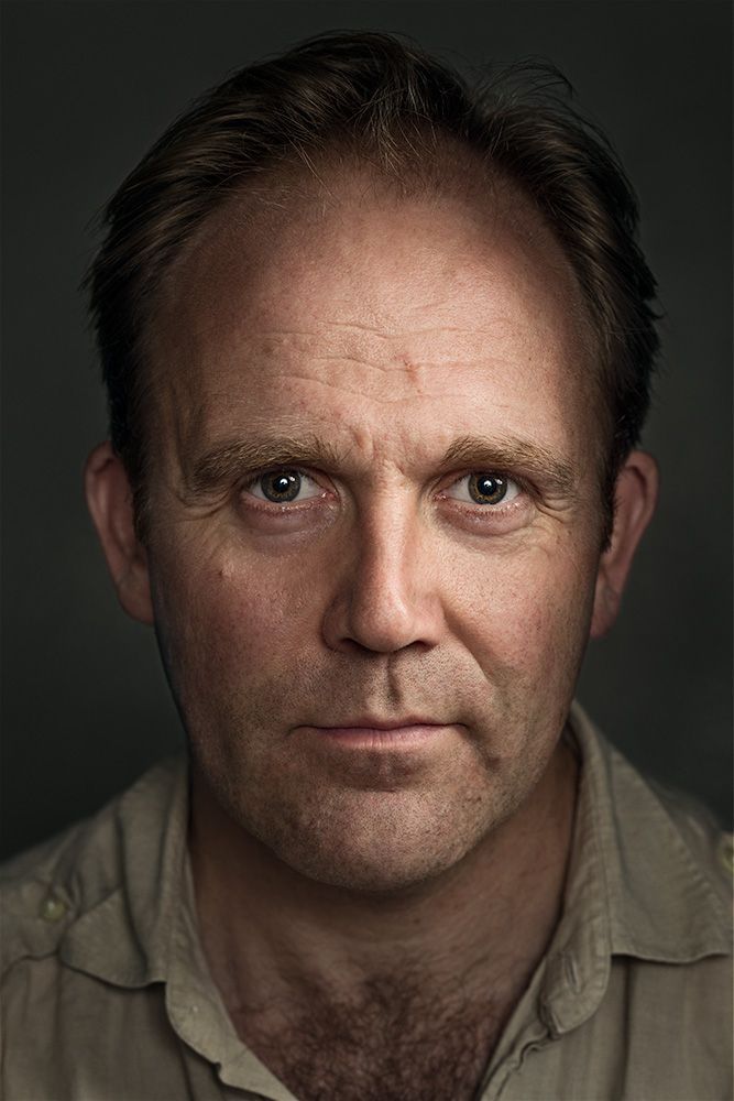 A classical photographic portraiture work, a close up of a man in incredible detail, with the eyes as a central focus.