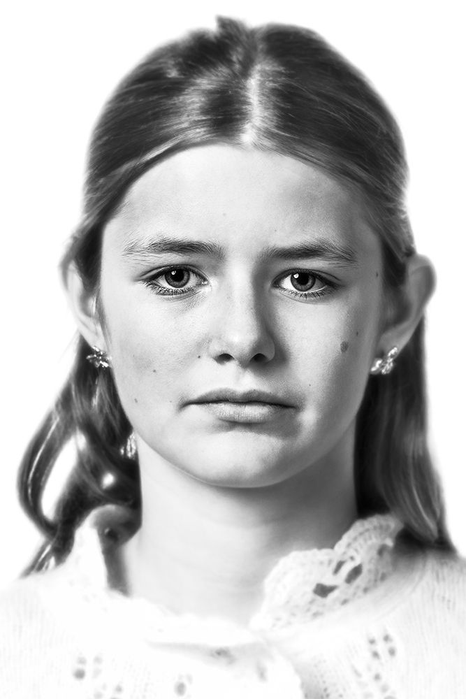 A classical photographic portraiture work, a close up of a young girl in incredible detail, shot in black and white.