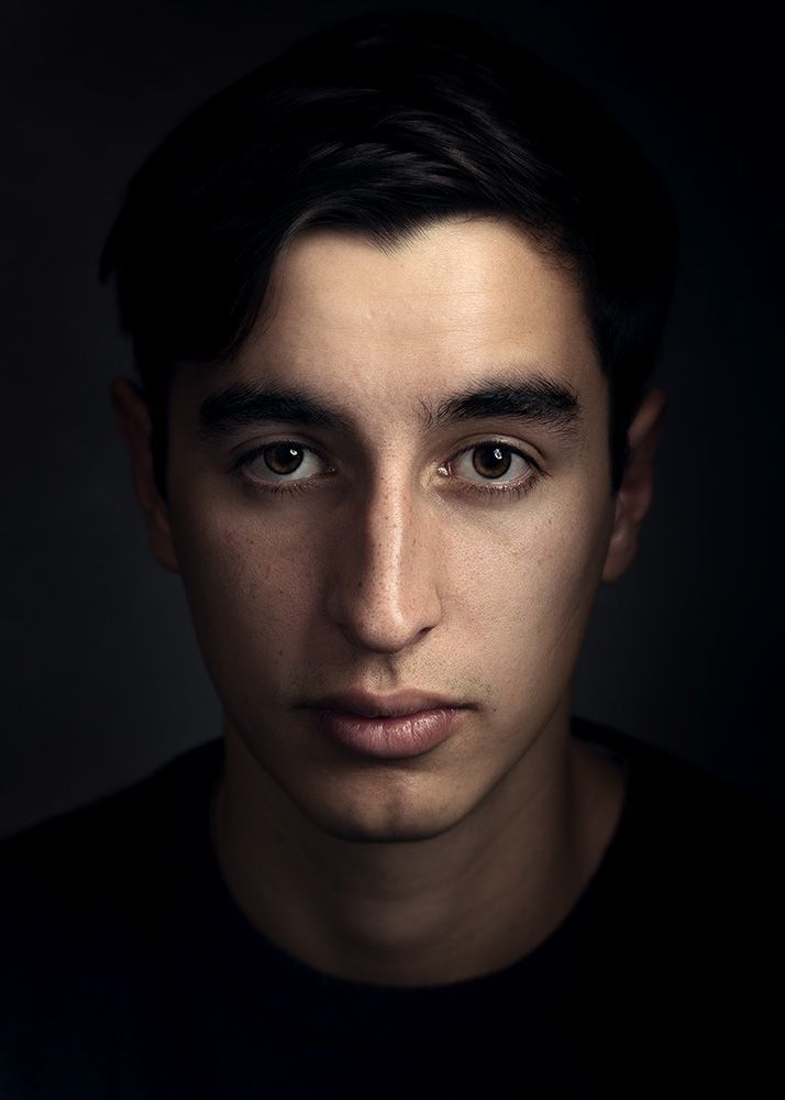 Stunning close up photo portrait of a young man using the latest fine art photo portrait photography techniques