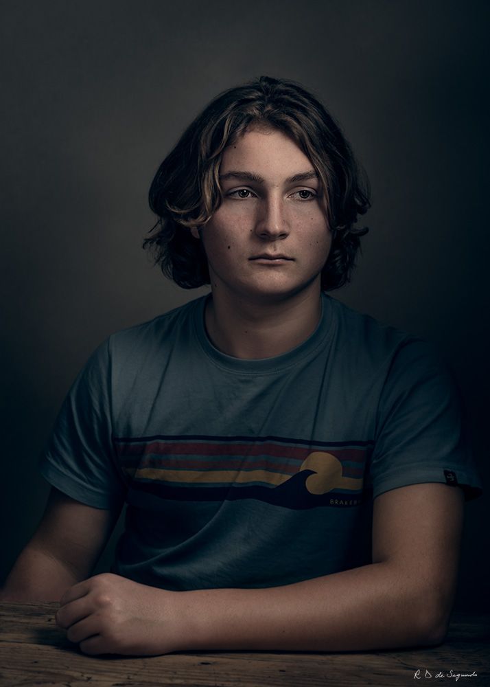 Studio fine art photo portrait of a young man using intricate lighting to emulate a soft media portrait from the Golden Age.