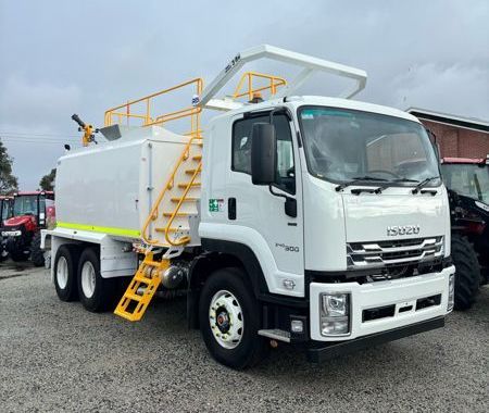 A white truck with a yellow ladder on the side is parked in a parking lot.