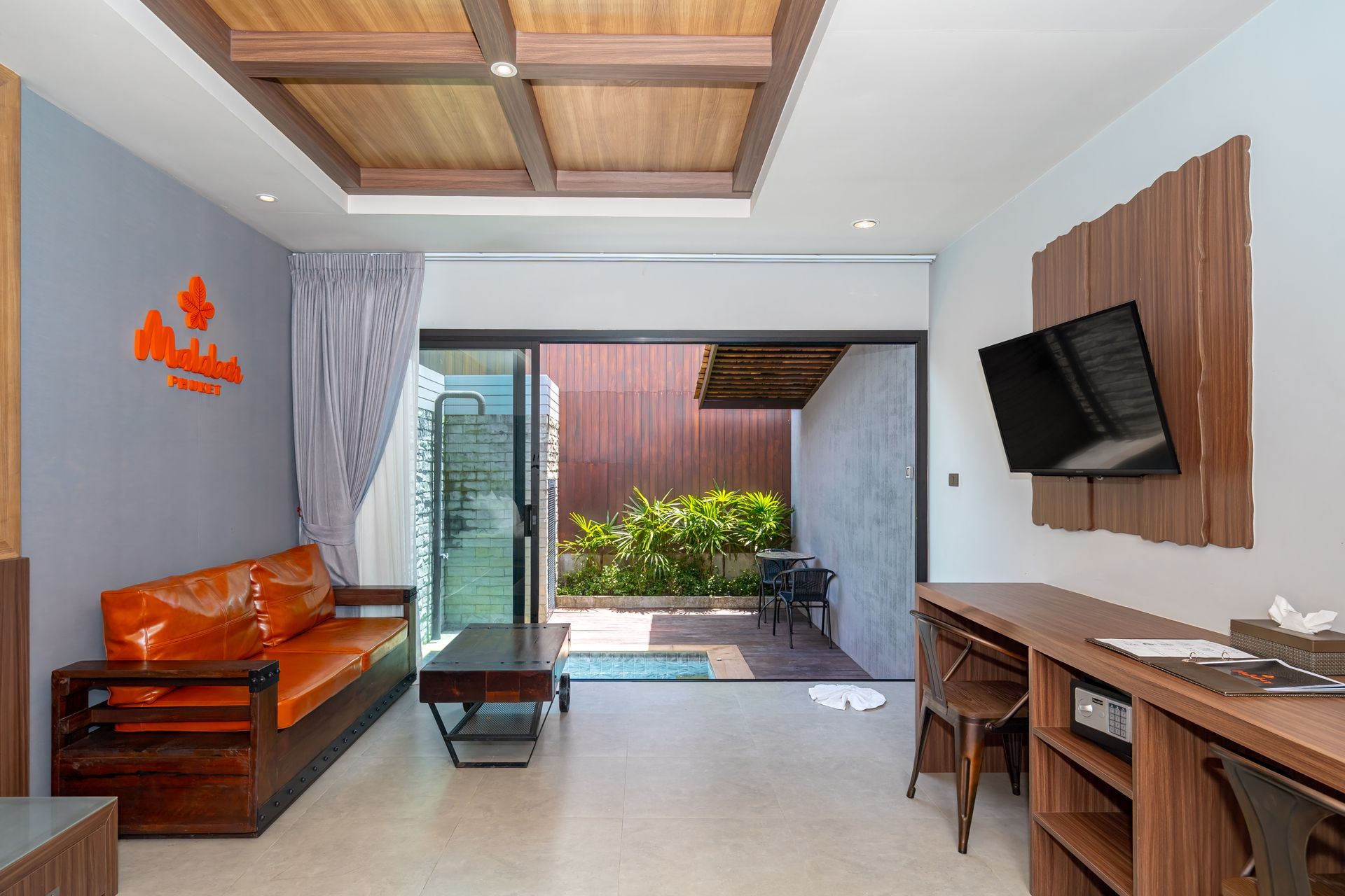 A living room with a couch , table , and television.