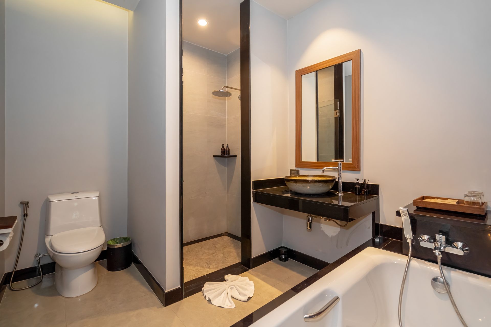 A bathroom with a toilet , sink , and bathtub.