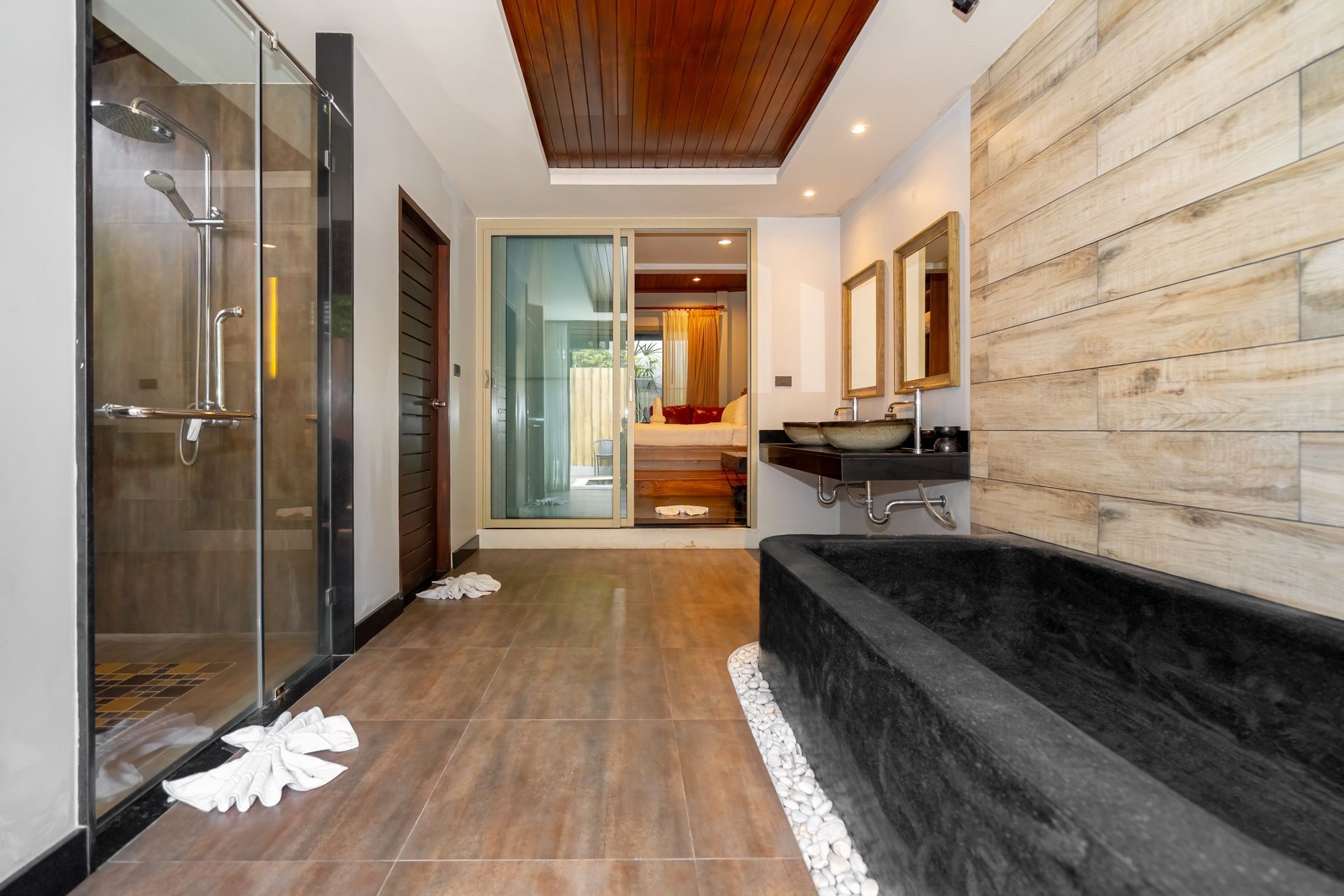 A bathroom with a bathtub , sink , and shower.