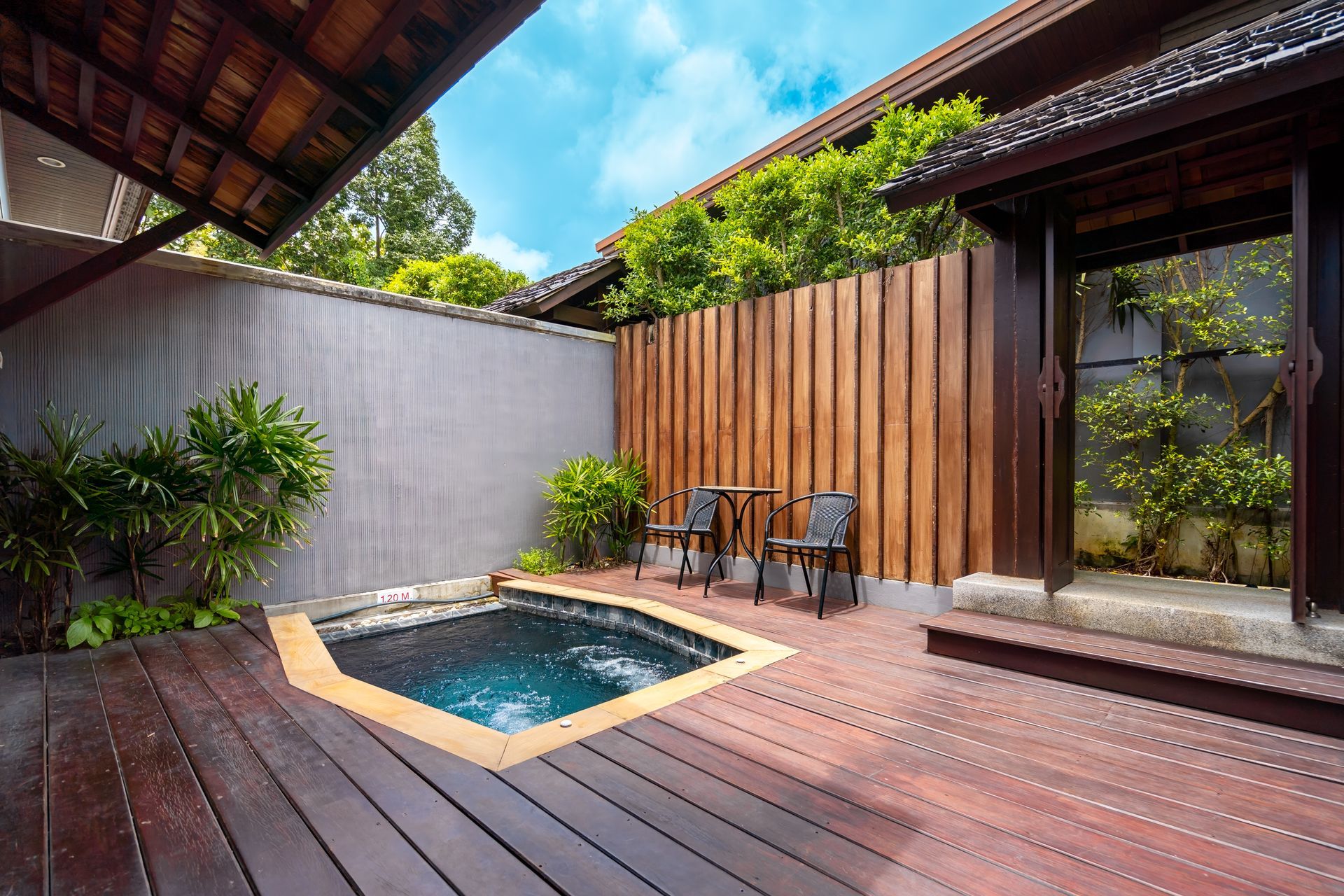 A wooden deck with a small pool in the middle