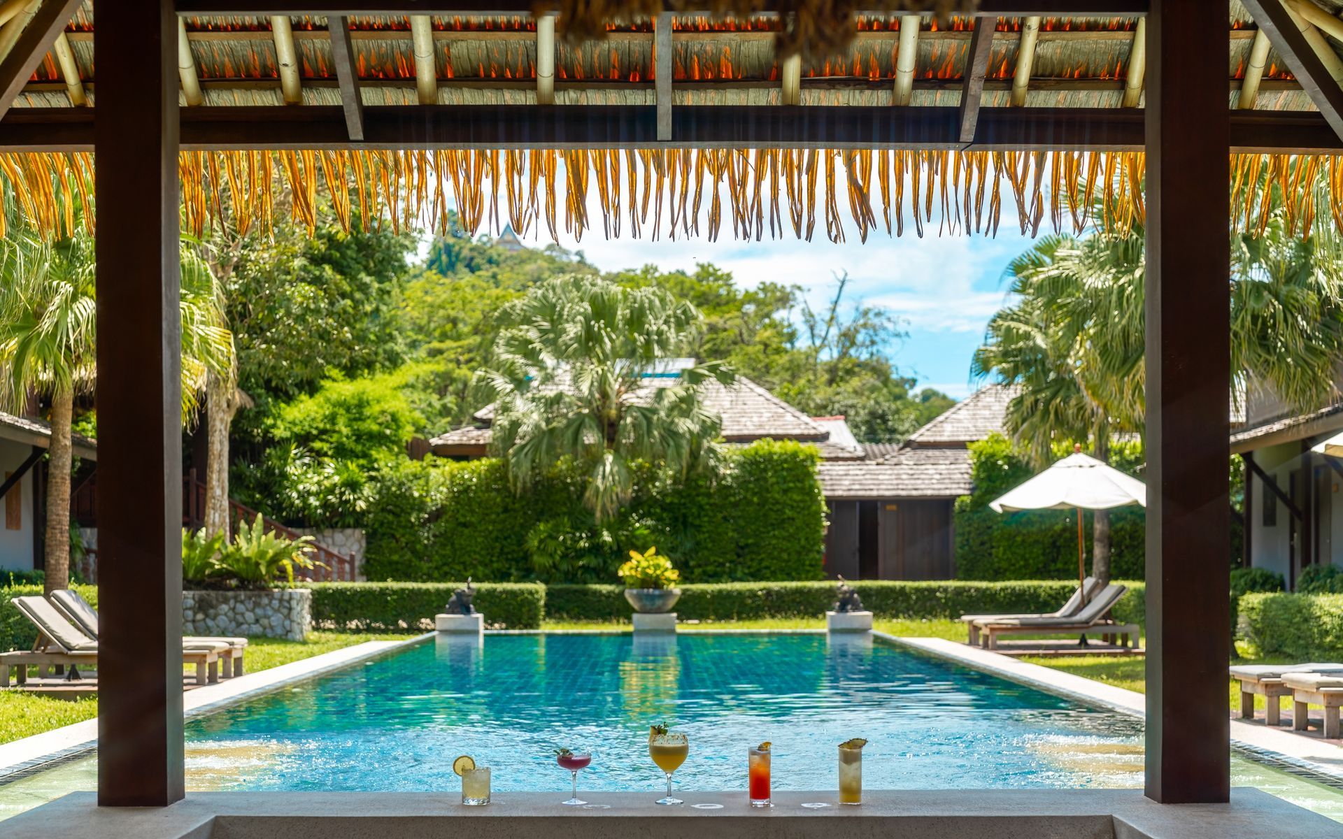 A view of a large swimming pool from a gazebo.