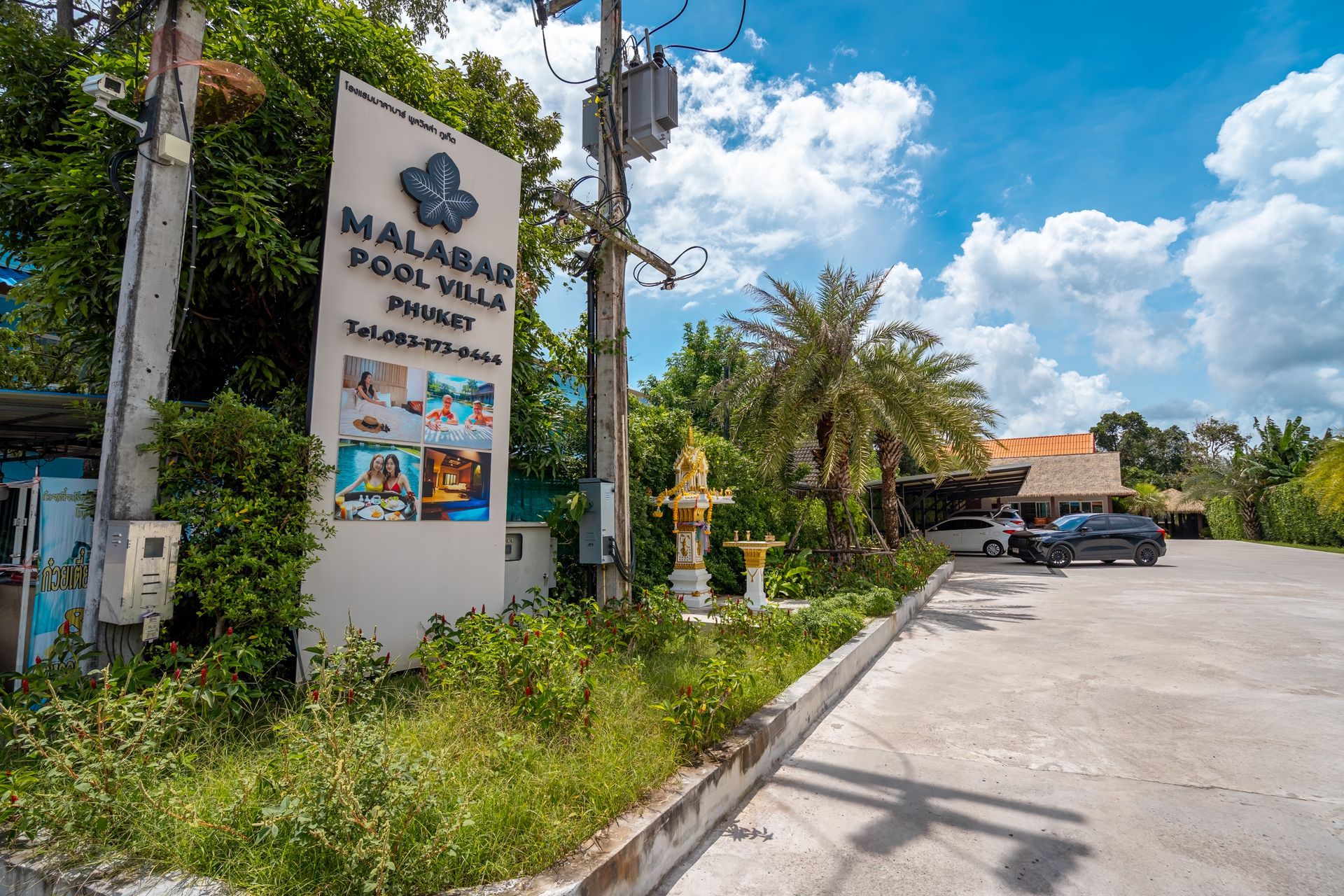 A large white sign is sitting in the middle of a parking lot.