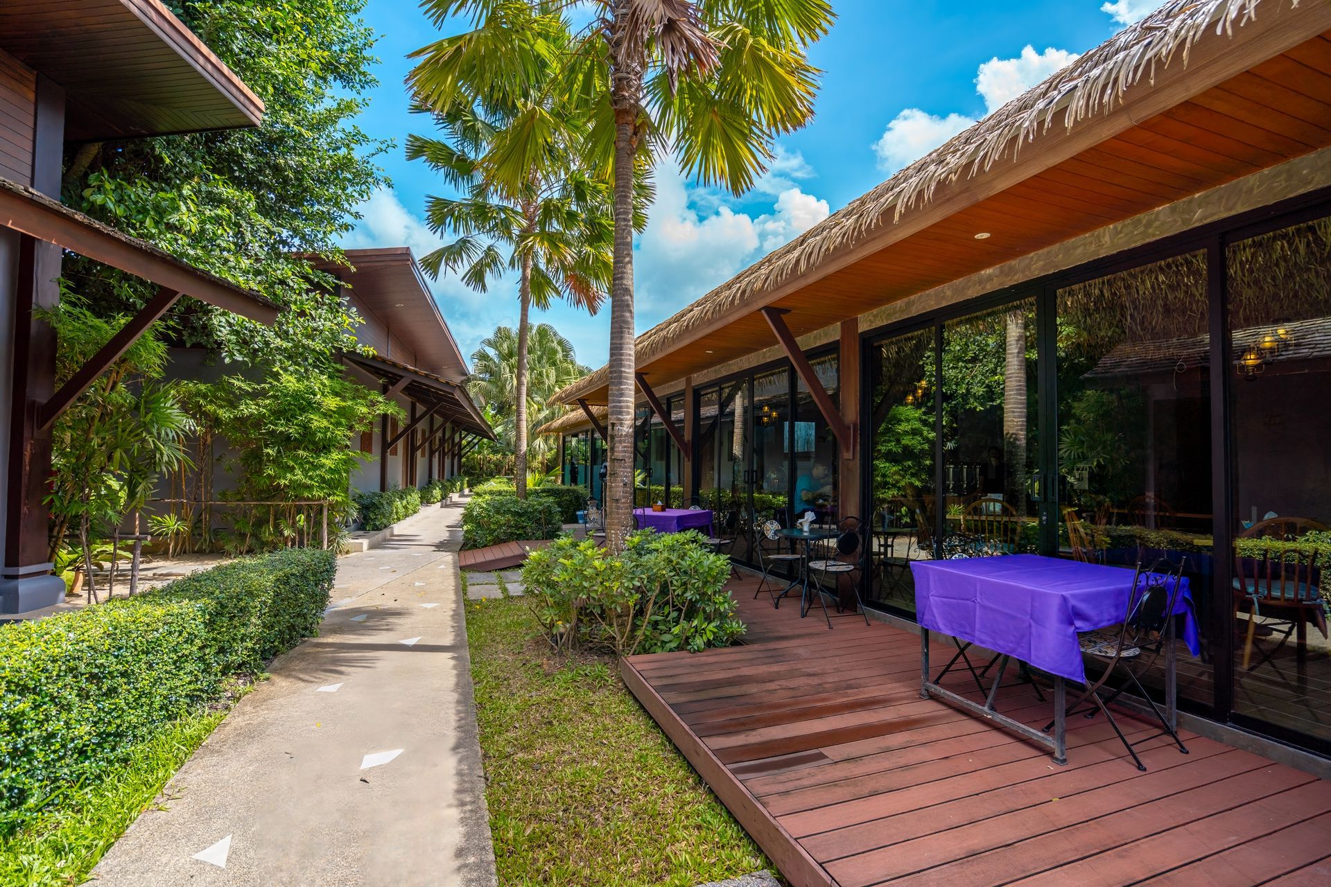 A patio with a purple table and chairs in front of a building.