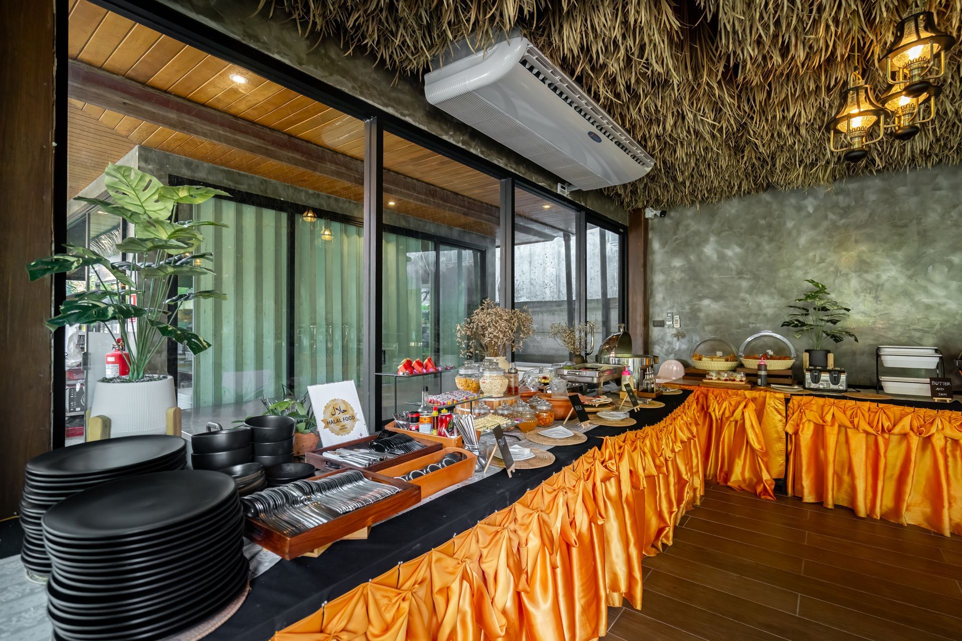 A buffet table in a restaurant with a lot of food on it.