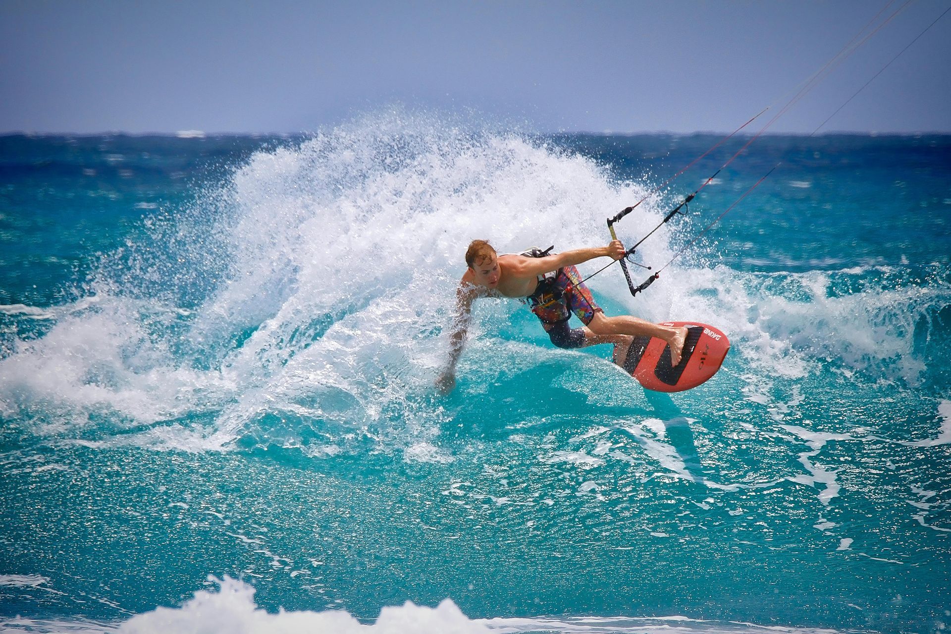 A man is riding a wave on a surfboard in the ocean.