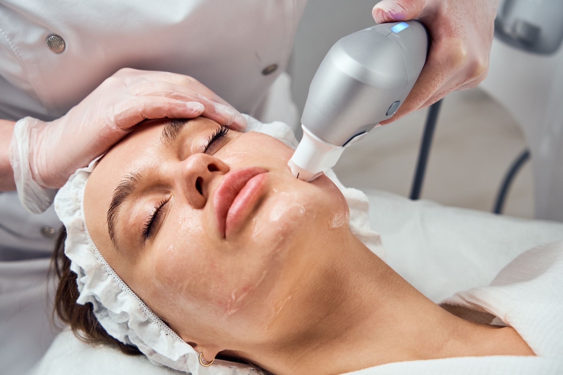 A woman is getting a facial treatment at a beauty salon.