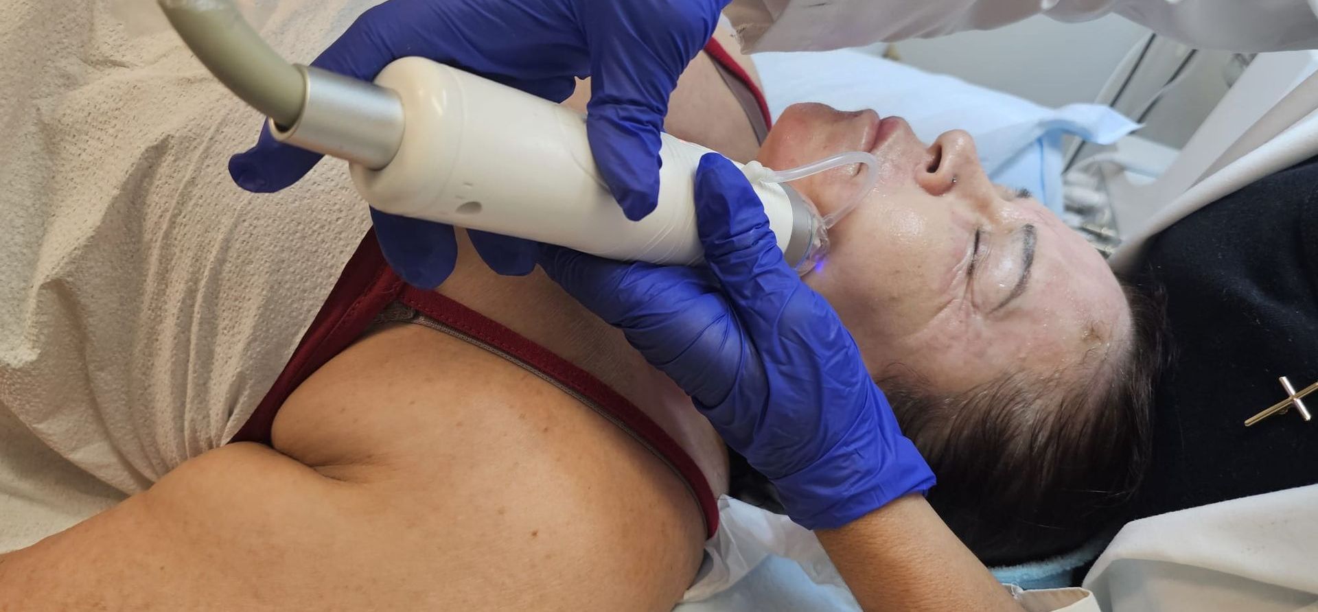 A woman is getting a facial treatment in a beauty salon.