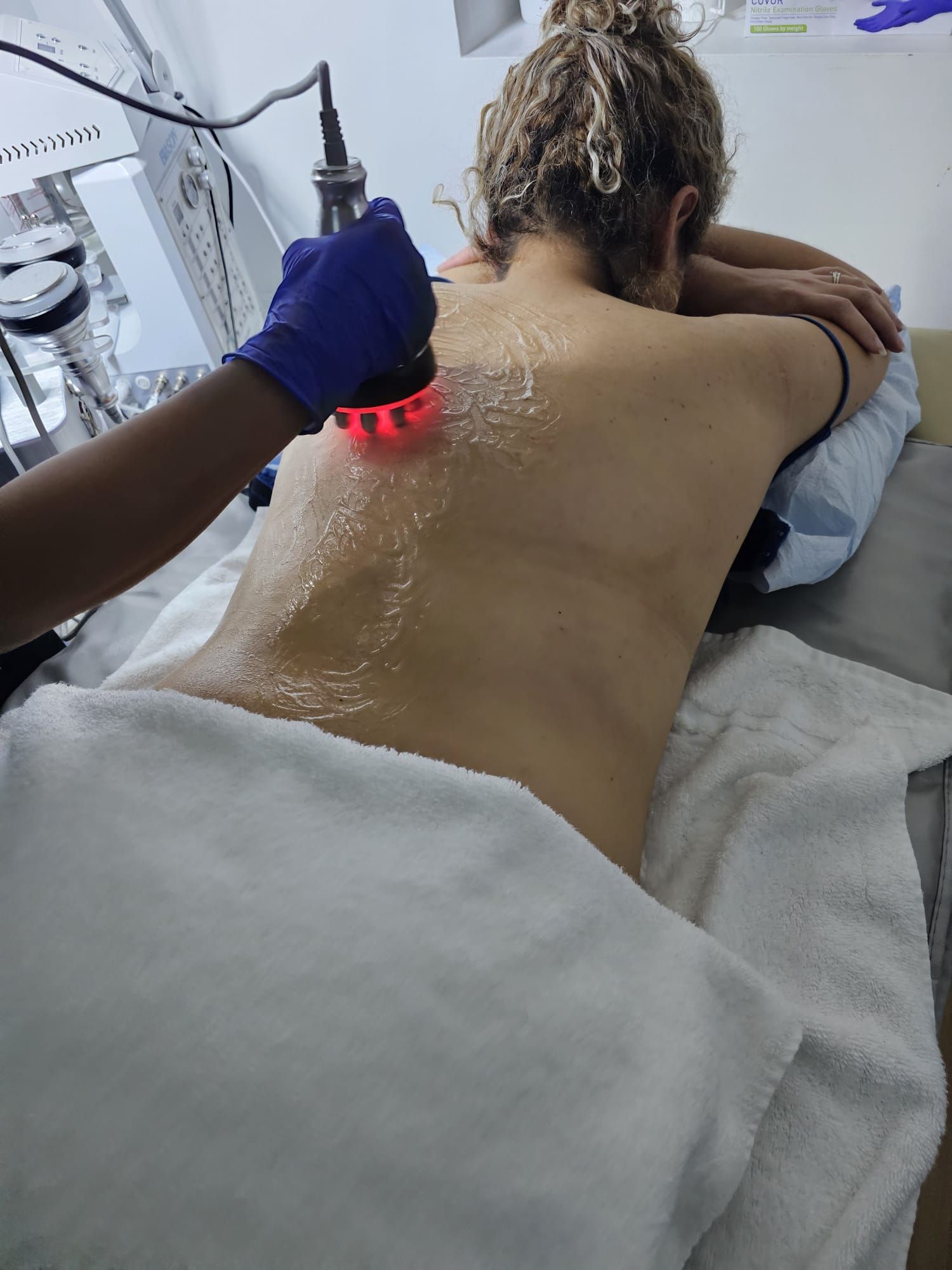 A woman is getting a massage on her back in a spa.