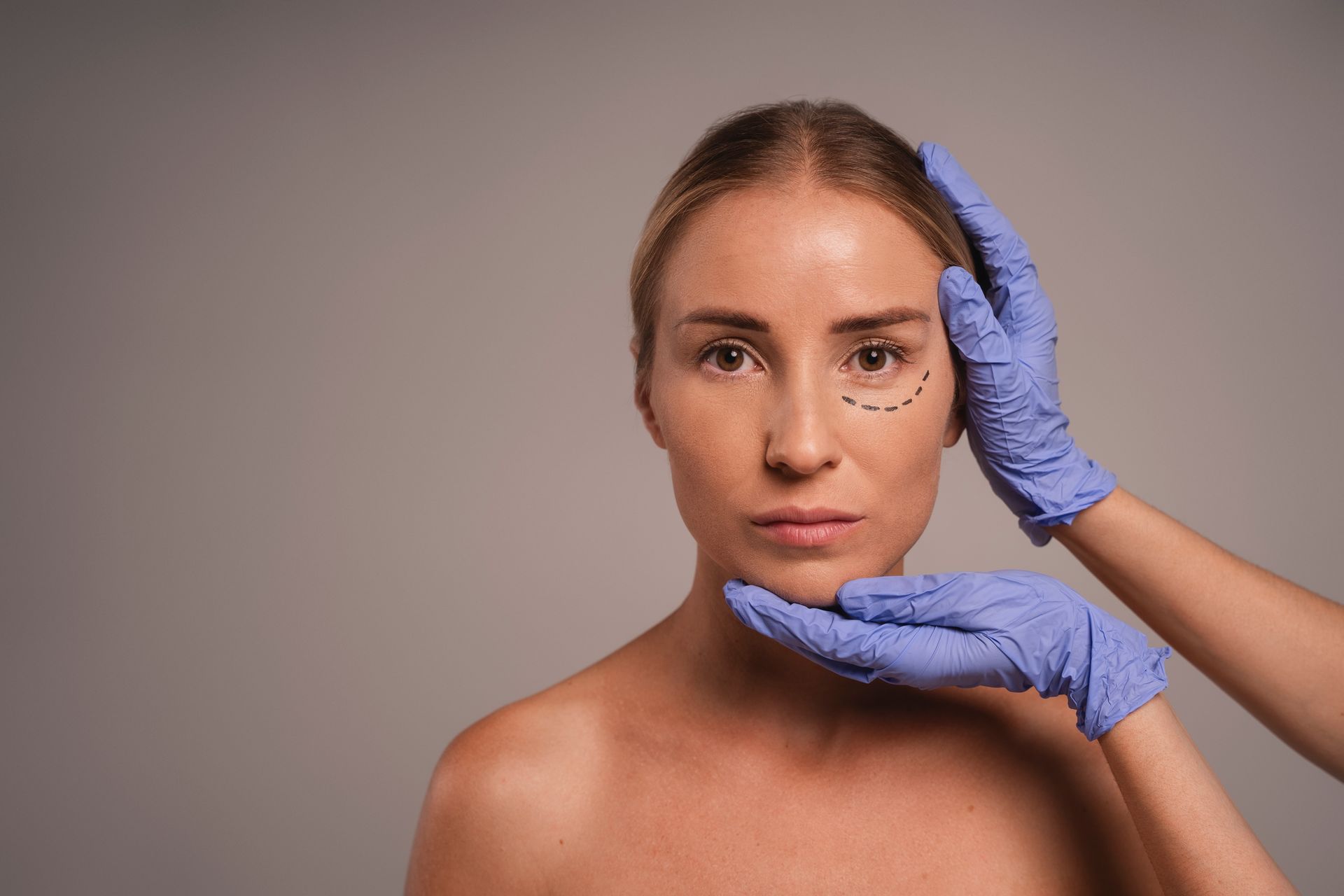 A woman is getting a cosmetic surgery on her face.