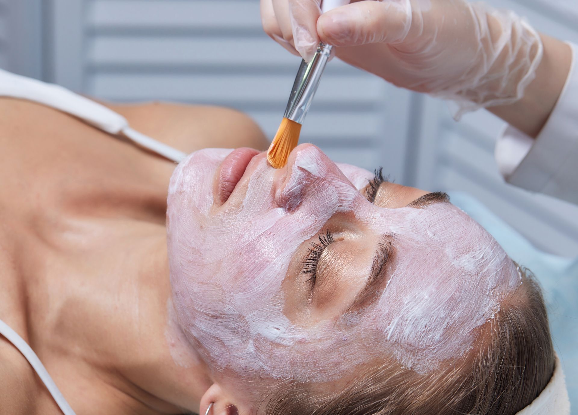 A woman is getting a facial treatment at a spa.