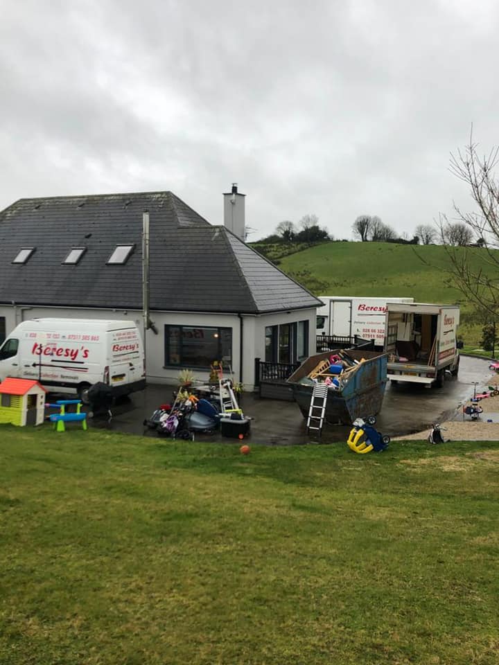 Multiple Beresy's House Removals' vans at building with skip outside