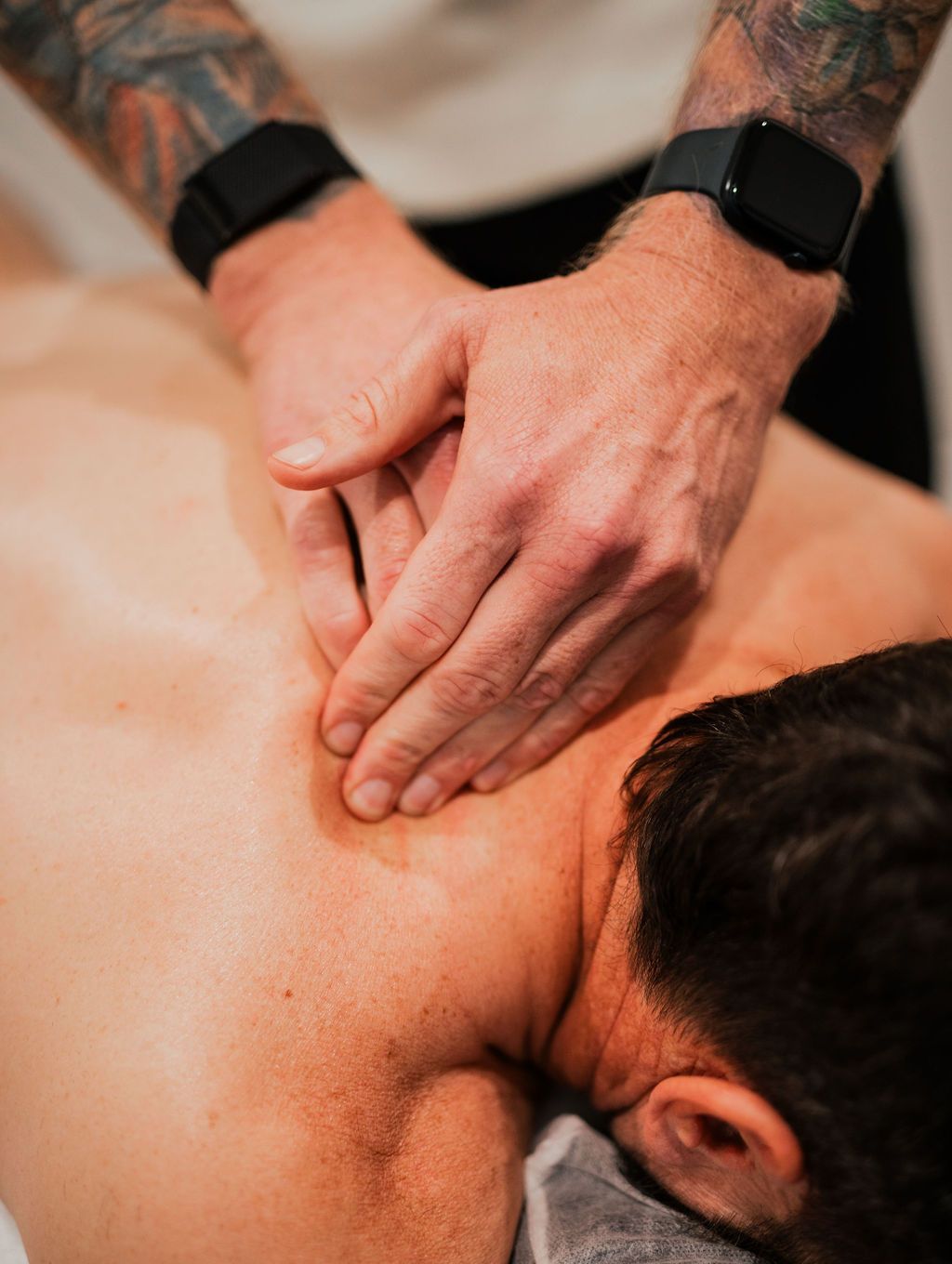A man is getting remedial massage on his back.