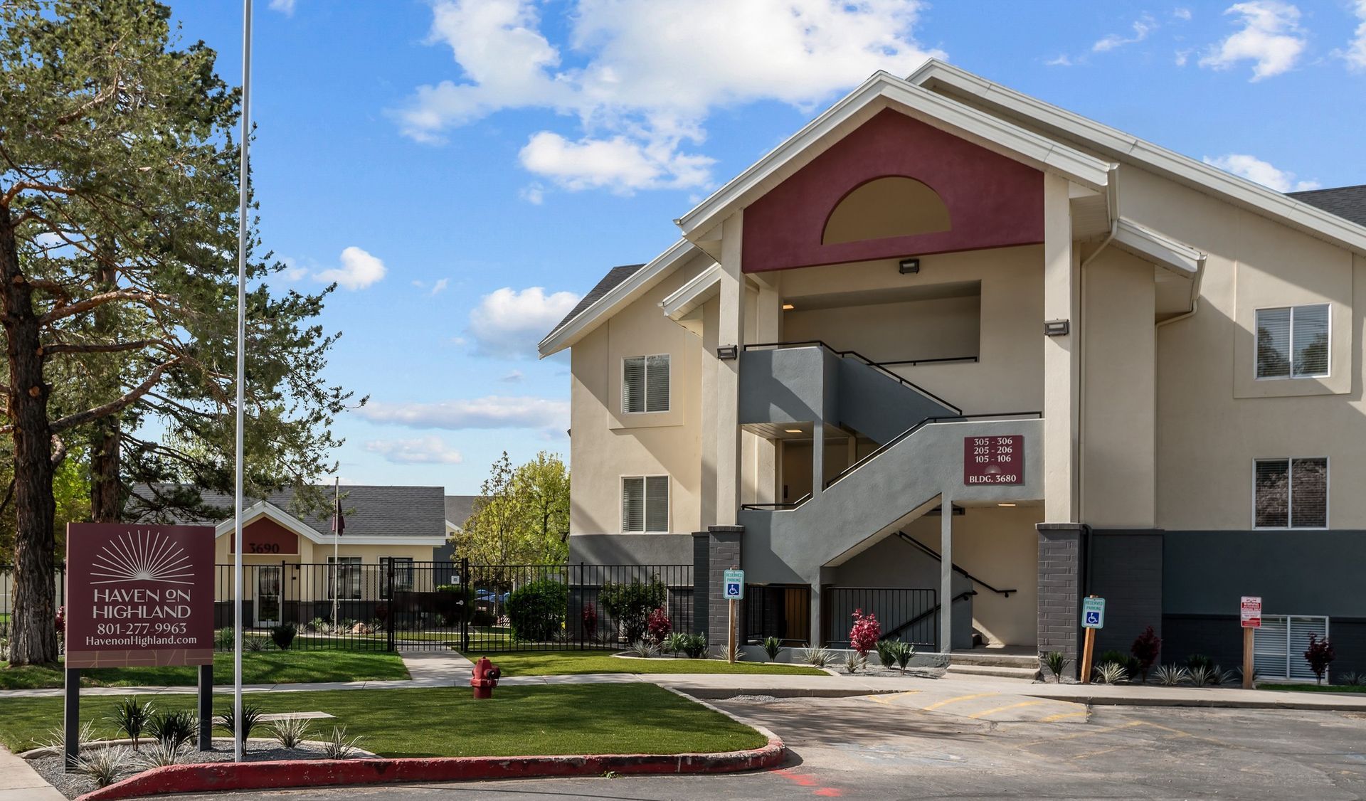 A large apartment building with stairs leading up to the second floor.