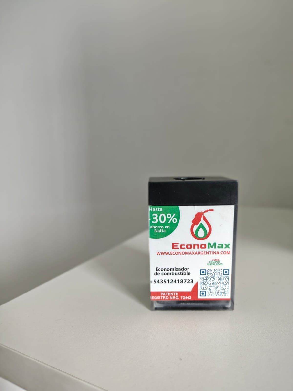 Contenedor de aditivo de combustible CconoMax negro sobre superficie blanca,