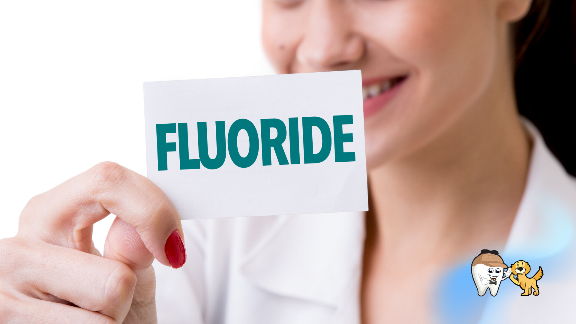 A woman is holding a card with the word fluoride on it.