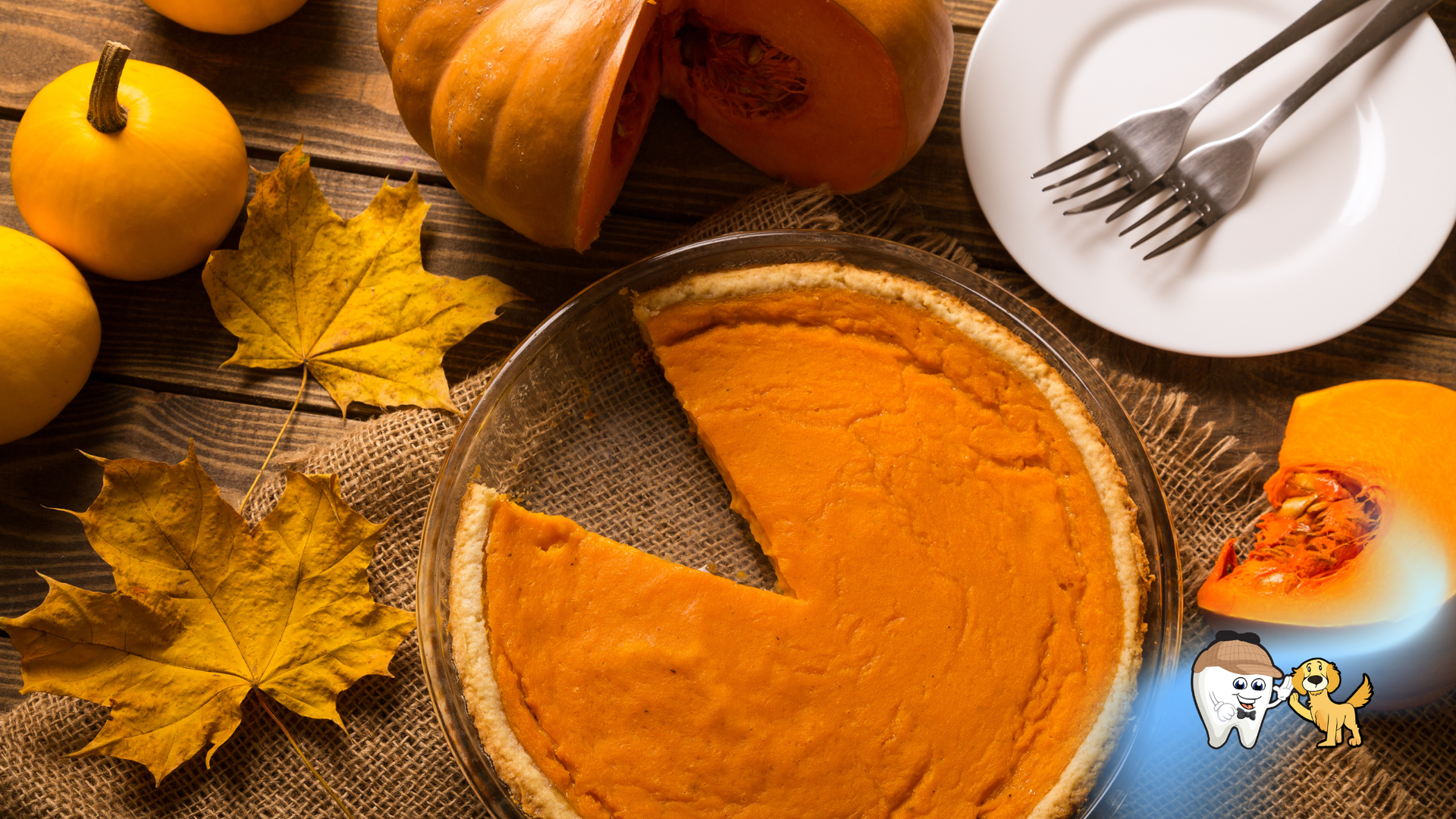 Pumpkin pie with a slice missing, pumpkins, leaves, and a plate with silverware on a wooden table.