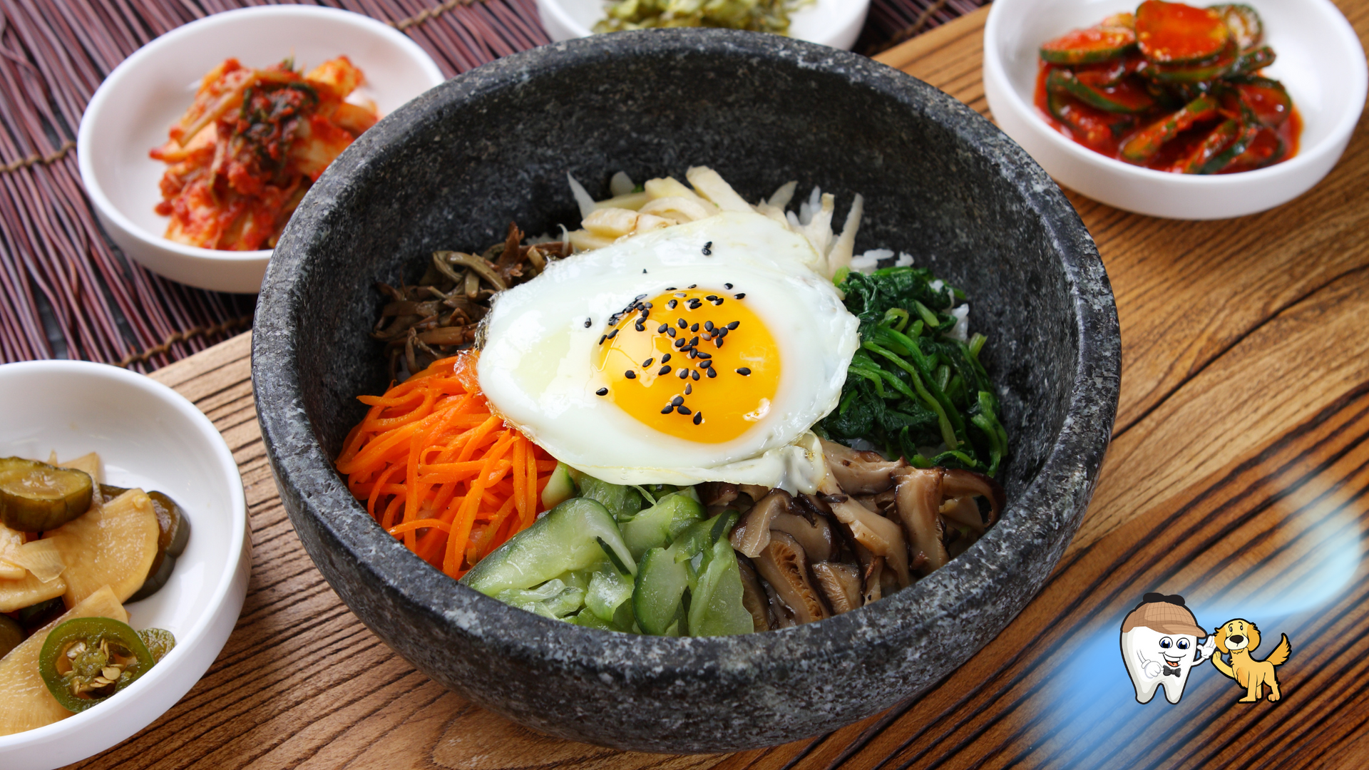 Bibimbap in stone bowl with side dishes: kimchi, pickled vegetables. Korean cuisine.