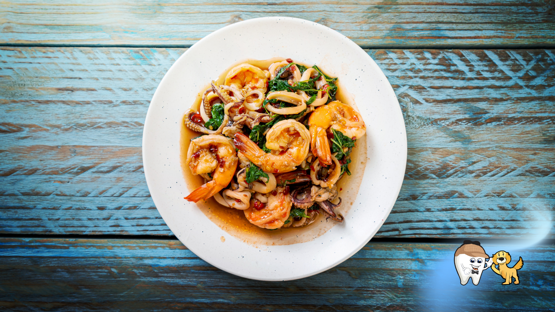 Seafood stir-fry with shrimp and squid on a white plate, blue wooden background.
