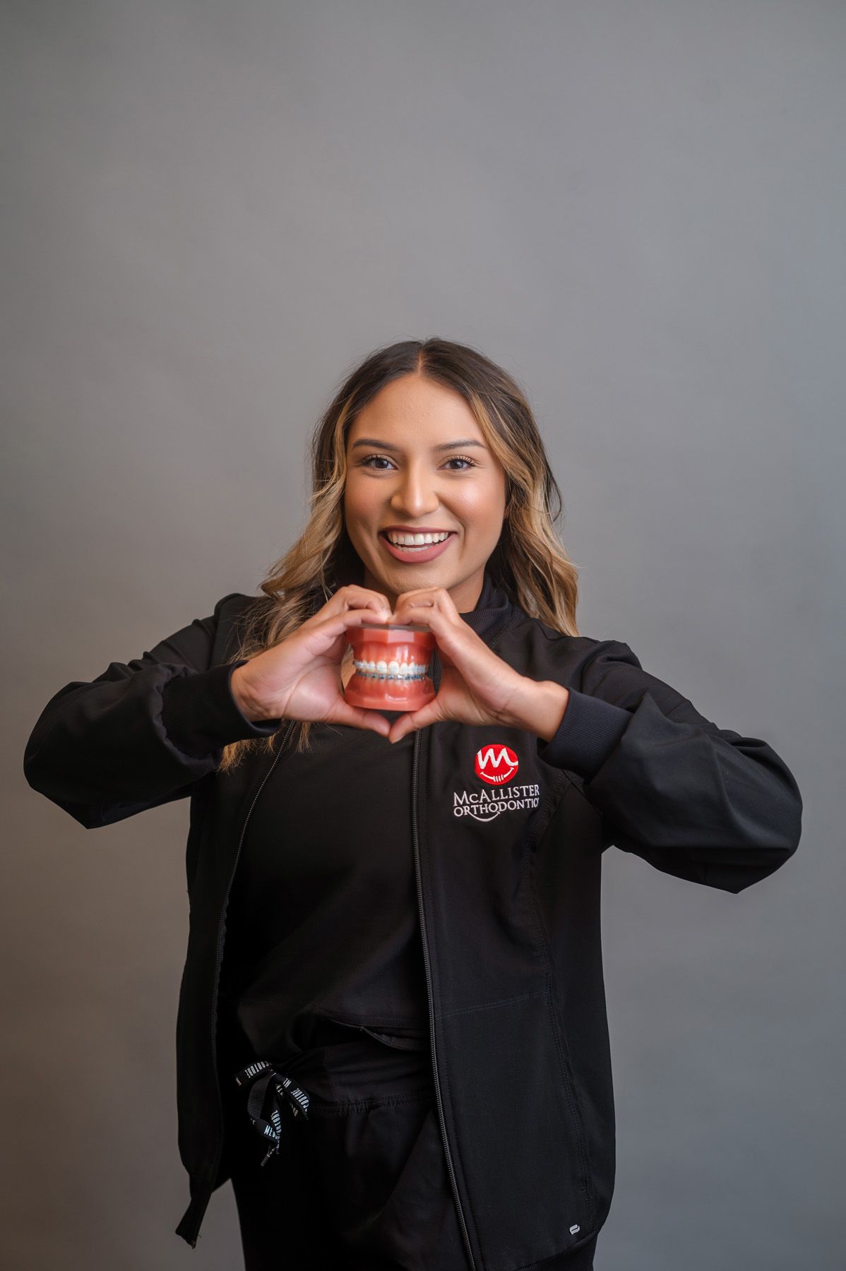 A man wearing a cowboy hat and sunglasses is holding a football.