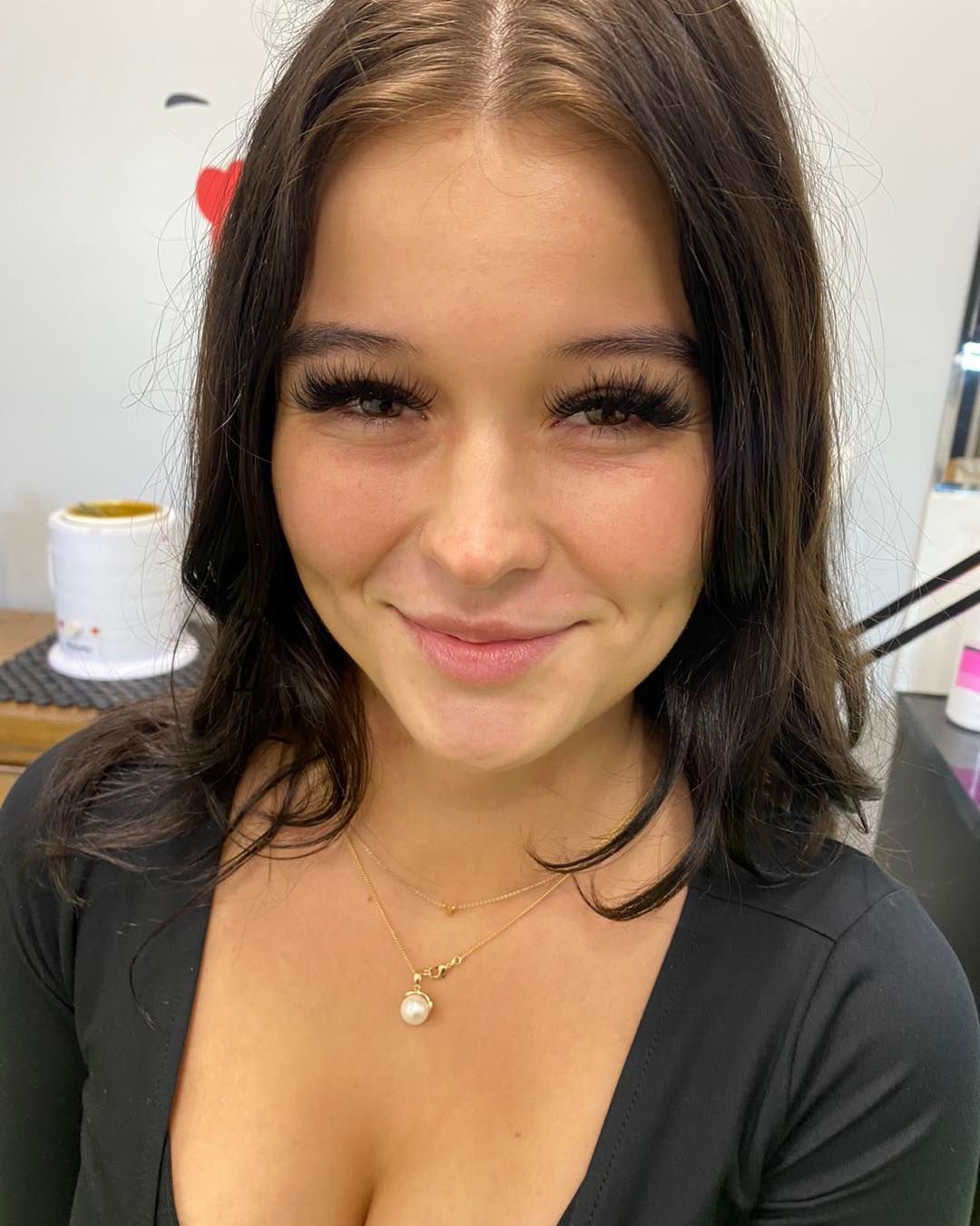 Woman With Dark Hair And Long Eyelashes Smiles At The Camera — Penelope's Beauty in Raymond Terrace, NSW