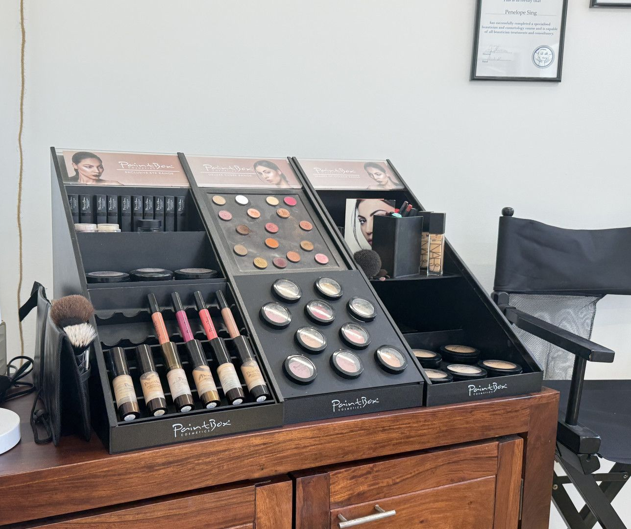 Makeup Display On A Wooden Cabinet — Penelope's Beauty in Newcastle, NSW