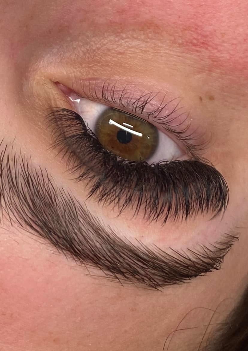 Woman With Long Eyelashes And Light Makeup Looking At The Camera In A Salon — Penelope's Beauty in Newcastle, NSW
