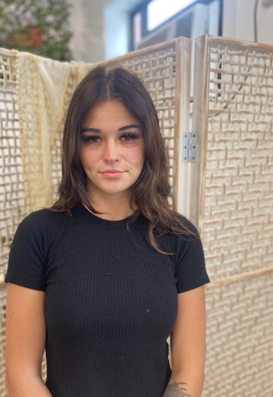 Woman With Dark Hair Smiles, Wearing An Off-shoulder — Penelope's Beauty in Raymond Terrace, NSW